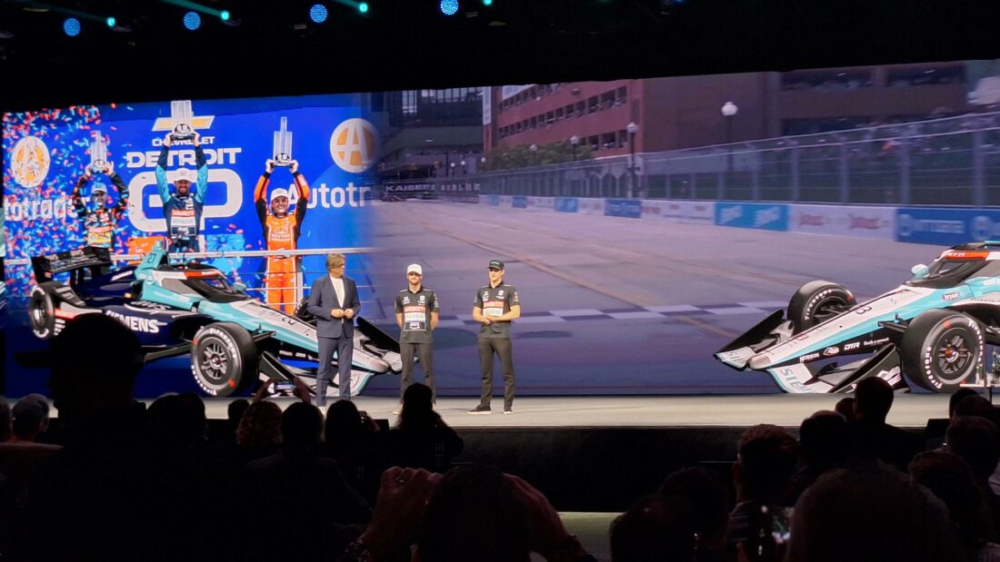 Formula drivers at the event with Siemens branding, showcasing the fusion of cutting-edge tech and motorsports.