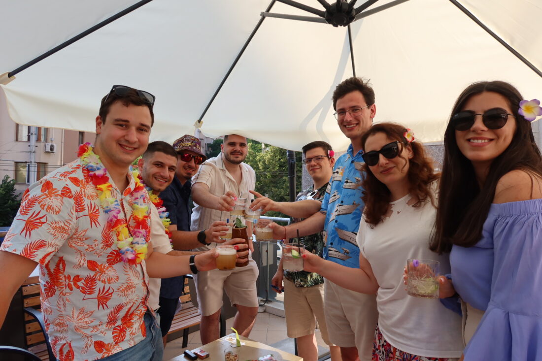 Team members enjoying the summer terrace party under the sun