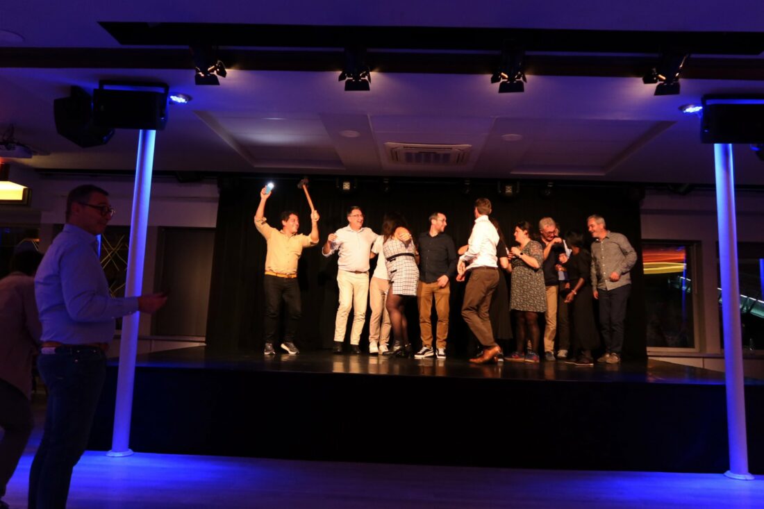 Inensia boat party at night with music, dancing, and city lights reflecting on the water