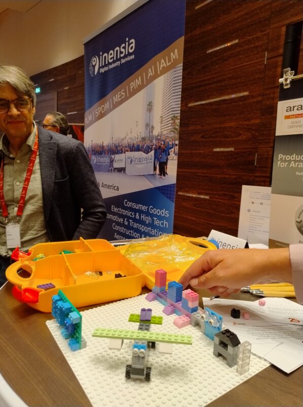 Inensia's representative communicating with people during the Aras Connect Event in Germany.