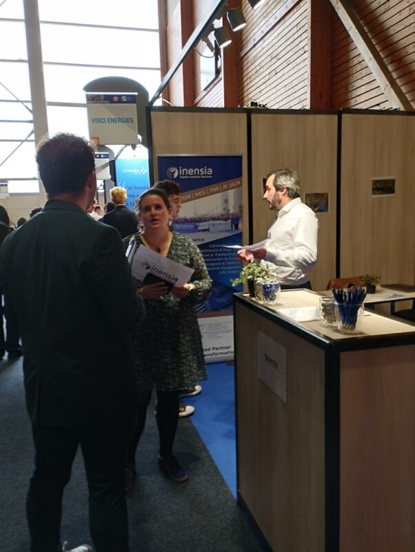 Inensia's representative talking with students during the UTT career event 2025